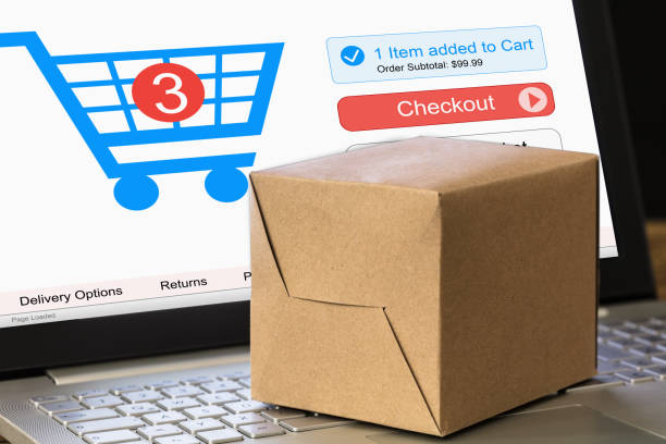 istock Cardboard Box On Laptop With Shopping Cart Displayed On Screen 922107160