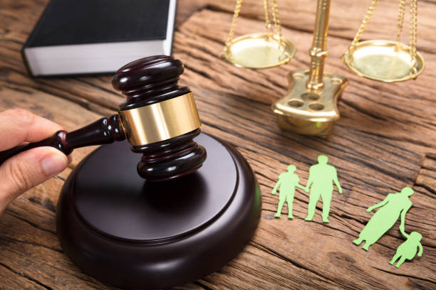 istock Judge's Hand Hitting Mallet By Separated Paper Family 922107218