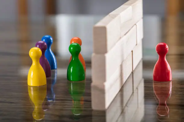 Photo of Red And Blue Figurine Paw Separated By Wooden Blocks