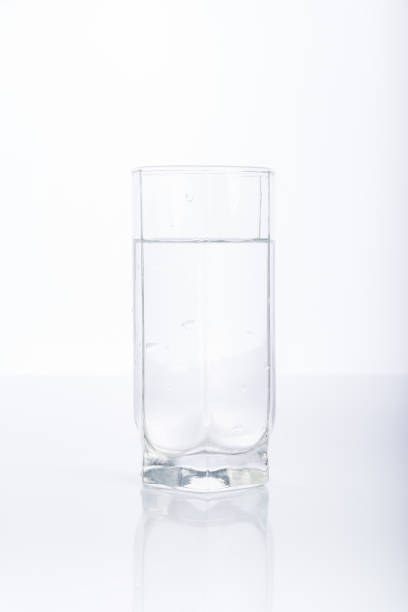 istock Glass of purified water on white background, reflection 922112032