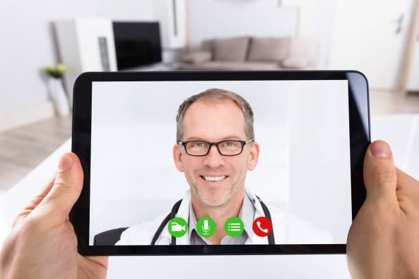 istock Person Video Conferencing With Doctor On Digital Tablet 922112292