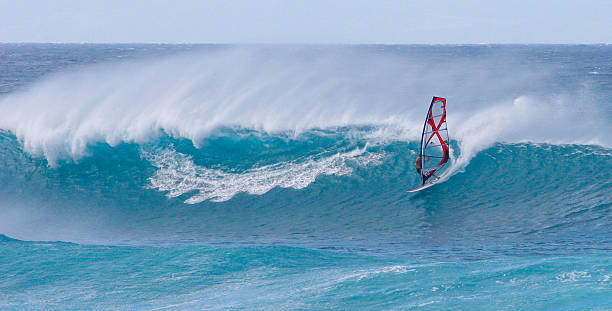 Young girl windsurfing in a blue sea in a summertime.