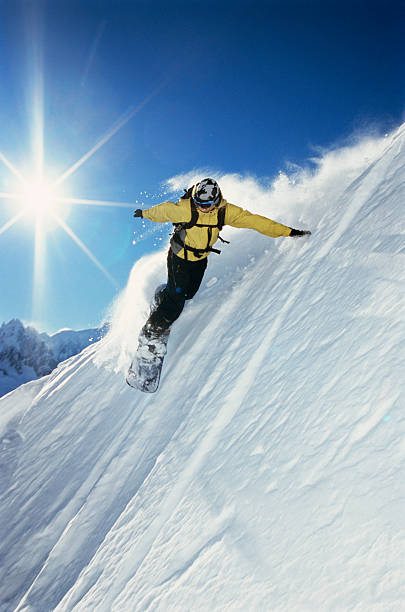 istock Woman in yellow snowboarding down a mountain 92211451
