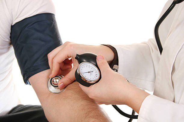 Female doctor using a stethoscope to check blood pressure hands with stethoscope annual event stock pictures, royalty-free photos & images