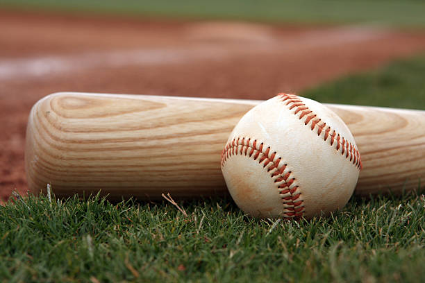 Close-up if baseball and bat resting on the field Baseball and bat near first base baseball bat stock pictures, royalty-free photos & images