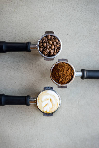 ground coffee in porta filter with beans - tamper imagens e fotografias de stock