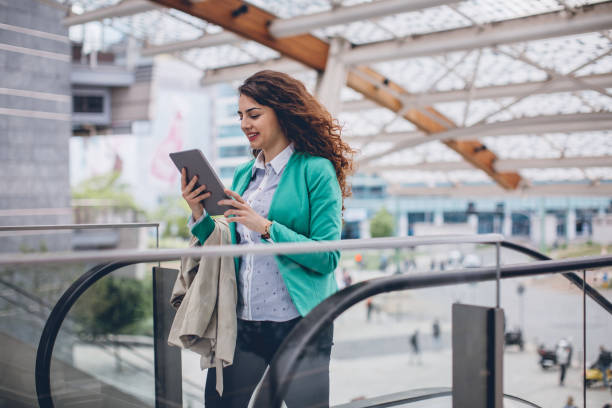 istock Businesswoman on the escalators 922124748