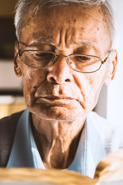 istock Senior man reading book, close-up shot 922127296