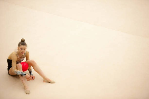 Tired Teenage Rhythmic Gymnastics Athlete Sitting..