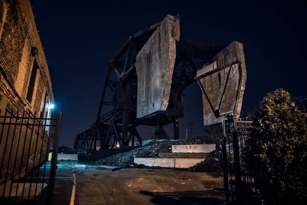 istock Massive industrial Chicago Bascule railroad train bridge at night. 922130348