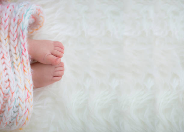 istock baby feet in blanket, copy space. selected focus 922141328