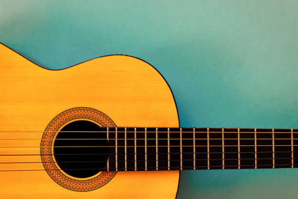 istock Acoustic classic guitar on blue background. Simple musical instrument with copy space. 922141358