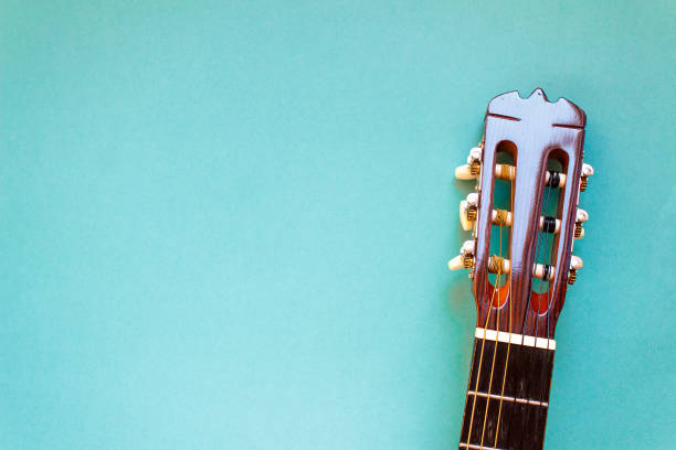 istock Acoustic classic guitar head on blue background. Simple musical instrument with copy space. 922141364