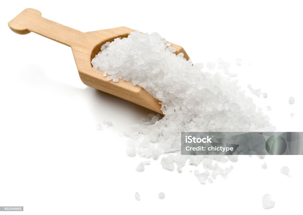 Salt Sea salt in a serving scoop.  Salt - Mineral Stock Photo