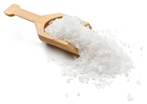Salt Sea salt in a serving scoop.  salt mineral photos stock pictures, royalty-free photos & images