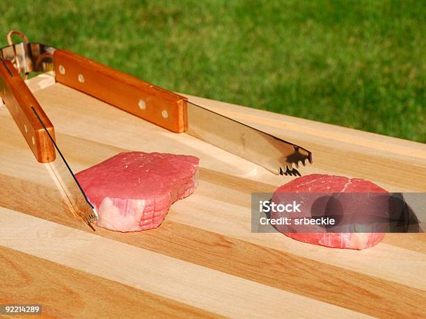 Raw Steak With Tongs Stock Photo - Download Image Now - Beef, Color Image, Cutting Board