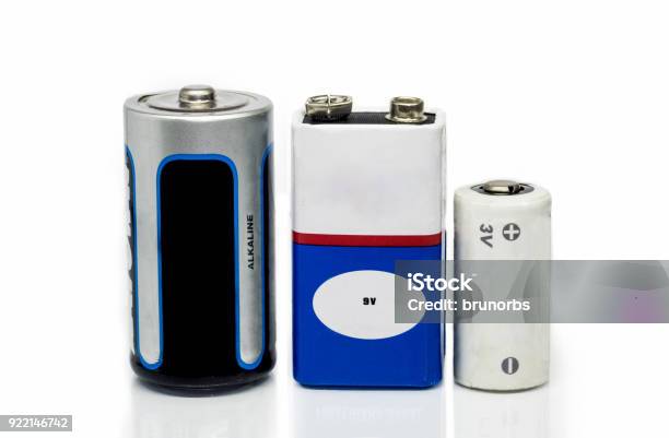 Alkaline Batteries 9v And 3v Batteries Isolated On A White Background With Reflective Surface Stock Photo - Download Image Now