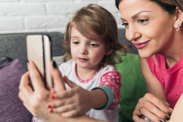 istock Mother and little daughter make some selfies 922153588