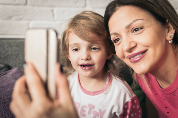 istock Mother and little daughter make some selfies 922153804
