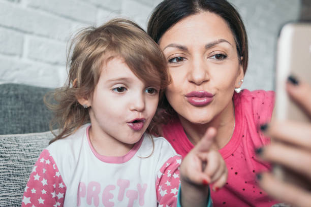 istock Mother and little daughter make some selfies 922153806