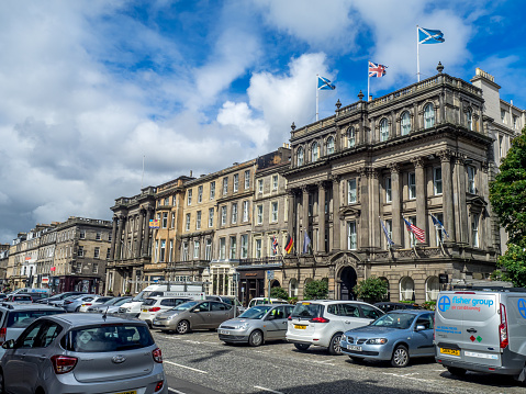 Edinburgh, Scotland - July 30, 2017: Buildings and shops on George Street in the New Town on July 30 2017 in Edinburgh, Scotland. The famous New Town is a main shopping area of Edinburgh.