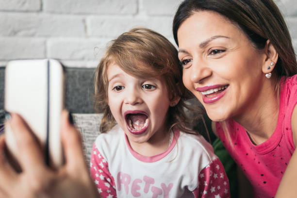 istock Mother and little daughter make some selfies 922153878