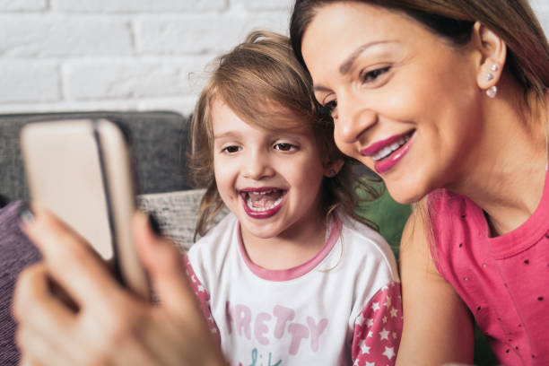 istock Mother and little daughter make some selfies 922153880