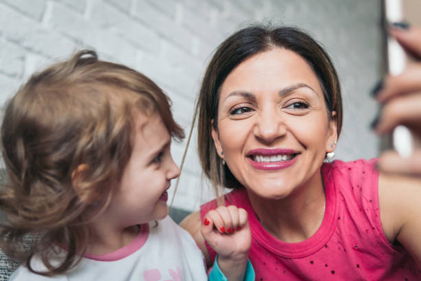 istock Mother and little daughter make some selfies 922153898