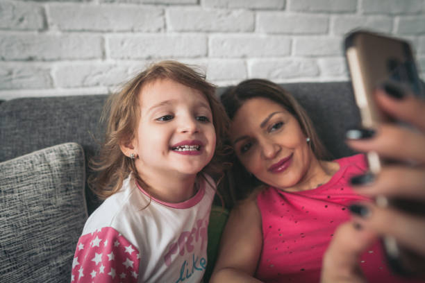 istock Mother and little daughter make some selfies 922158966