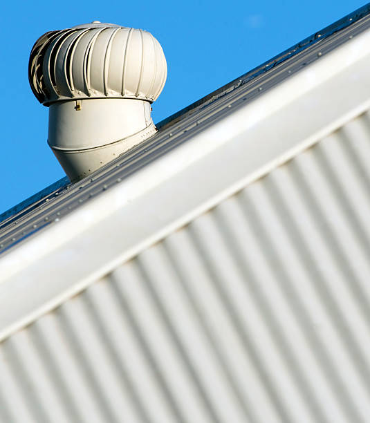 Wind turbine ventilator on corrugated roof stock photo