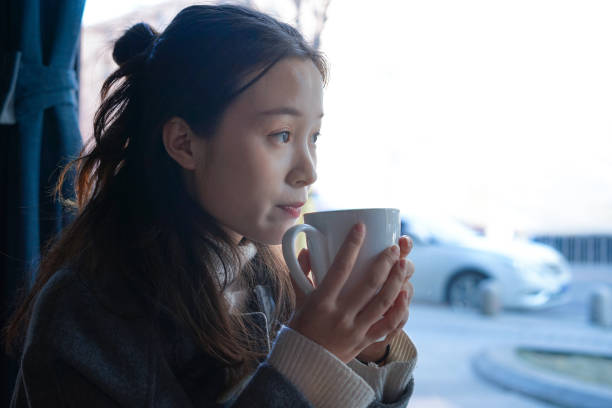 istock Beautiful girl drinking Coffee near Window 922169214