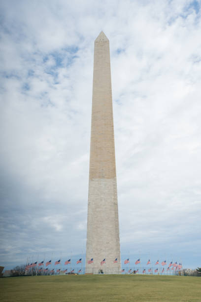 istock Washington Monument with American Flags at Half Mast and Clouds in Washington, DC 922176954