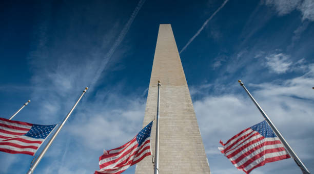istock American Flags at Half Mast behind Chain Link Fencing 922176978