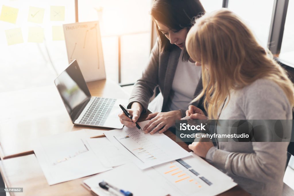 business working with woman and friend with laptop and paperwork with color tone effect Accountancy Stock Photo