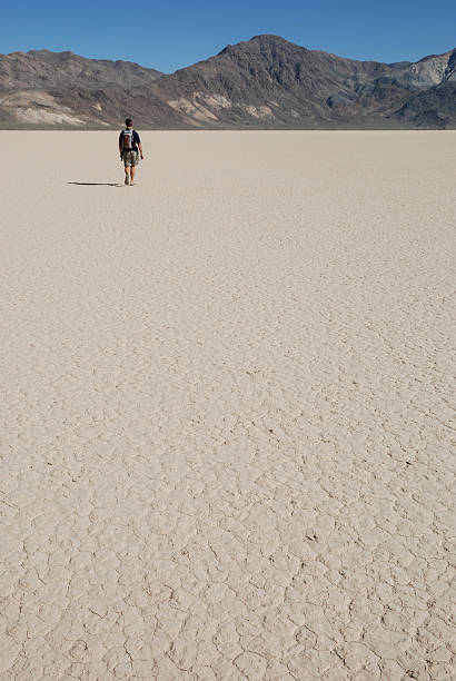istock Man Walking on Dry Lake Bed 92218297