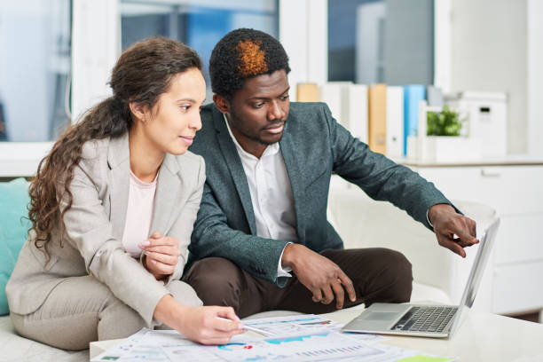 istock Confident business people viewing presentation in office 922189696