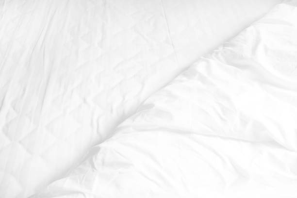 istock Close up of white bedding sheets and copy space 922201838