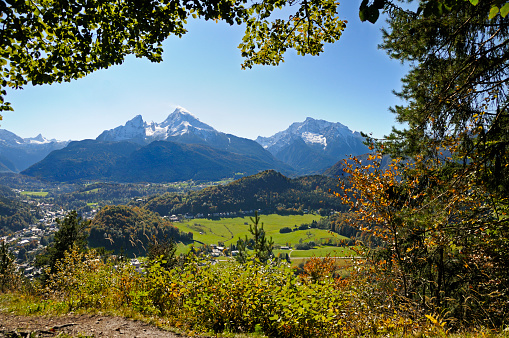 Hiker's vantage point, looking at a beautiful alpine valley, Watzmann mountain range and peak in the background. Watzmann, Germany, Bavaria, Berchtesgaden Alps.  Horizontal orientation.