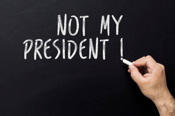 istock Hand writing Not my president with white chalk on blackboard. 922215162