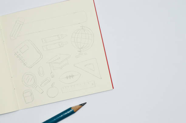 istock notebook with pencil sketches of school items on white background 922218102