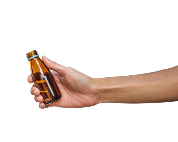 istock A man hand holding brown glass bottle isolated on white background with clipping path. 922221680