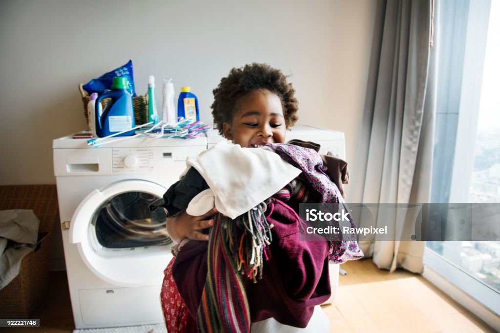 Young boy doing housework at home Child Stock Photo