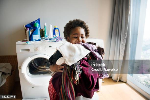 Young Boy Doing Housework At Home Stock Photo - Download Image Now - Child, Chores, Laundry