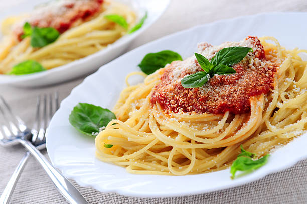 istock Two plates of spaghetti with tomato sauce and basil 92222581