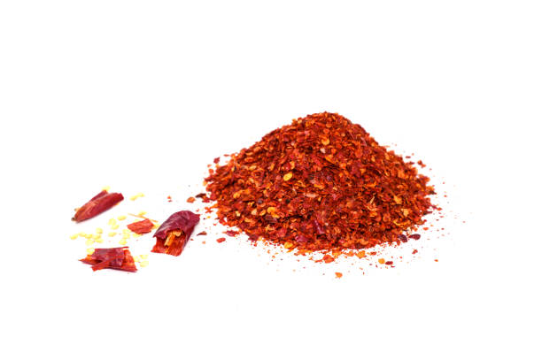 istock Red hot chilies with powder over white background. 922234318