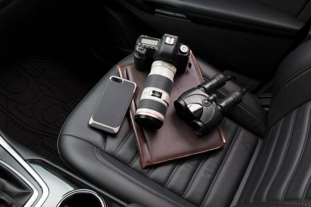istock Private investigator tools on car seat 922238792