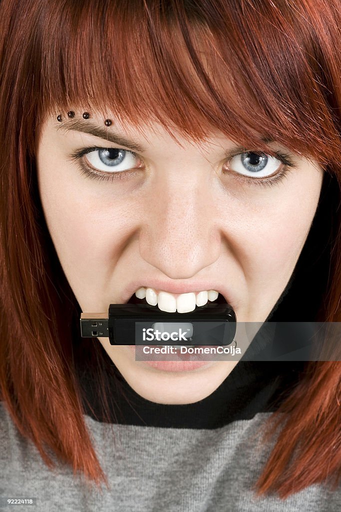 Aggresive girl biting memory stick  Adolescence Stock Photo