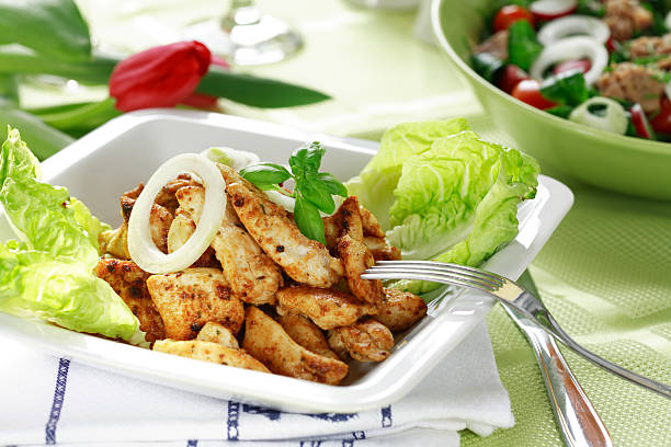Chicken stripes with salad  undressing stock pictures, royalty-free photos & images