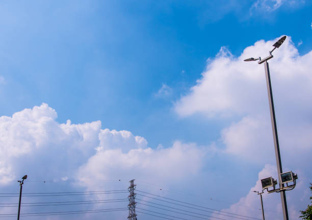 LED street lights on high steel pillars and blue sky