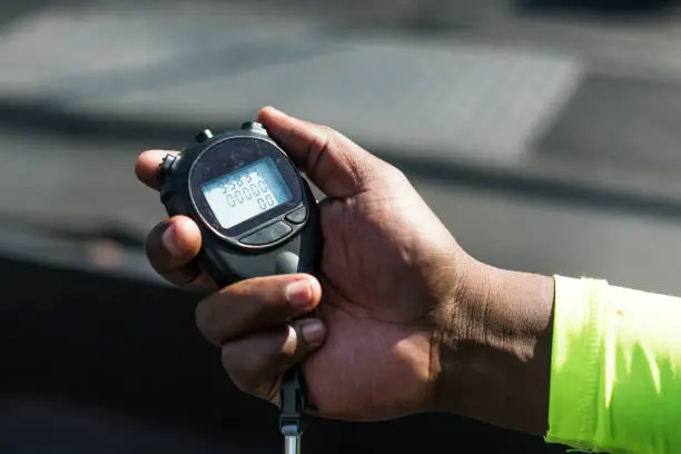 Photo of Closeup of hand holding stopwatch